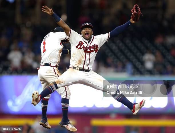 Left fielder Ronald Acuna, Jr. #13 and second baseman Ozzie Albies of the Atlanta Braves celebrate after the game against the Washington Nationals at...