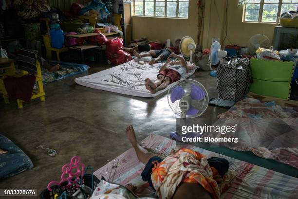 People rest inside a temporary evacuation center at Balzain East Elementary School ahead of Typhoon Mangkhut's arrival in Tuguegarao, Cagayan...