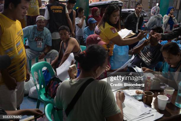 Local government employees work at a temporary evacuation center at Balzain East Multi Purpose Center ahead of Typhoon Mangkhut's arrival in...