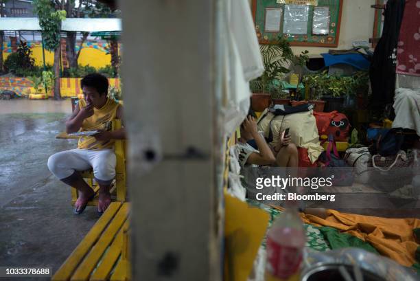 People gather at a temporary evacuation center at Balzain East Elementary School ahead of Typhoon Mangkhut's arrival in Tuguegarao, Cagayan province,...
