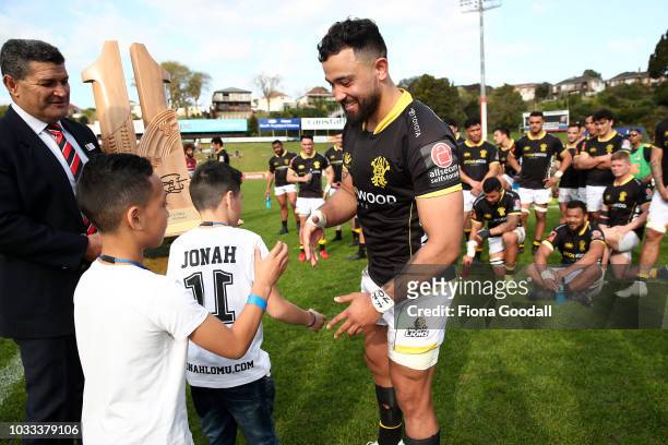 Matt Proctor, captain of Wellington is presented the Jonah Lomu Memorial Trophy by Jonah's sons Brayley and Dhyreille Lomu during the round five...