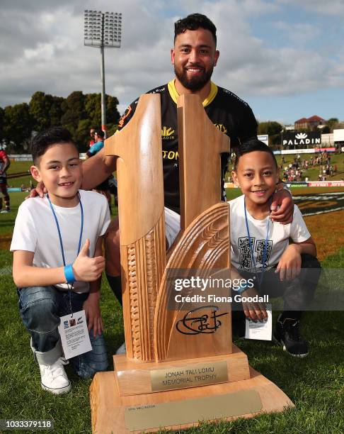 Matt Proctor, captain of Wellington is presented the Jonah Lomu Memorial Trophy by Jonah's sons Brayley and Dhyreille Lomu during the round five...