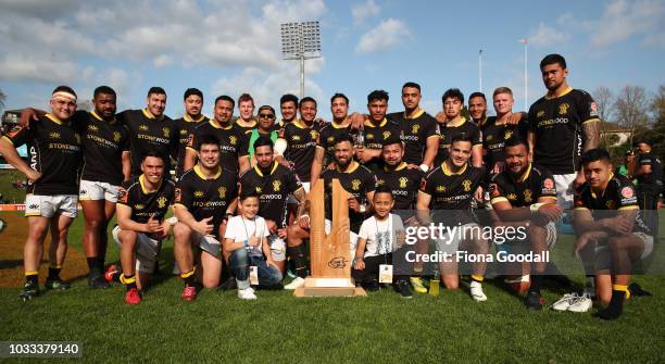 Matt Proctor, captain of Wellington is presented the Jonah Lomu Memorial Trophy by Jonah's sons Brayley and Dhyreille Lomu with the team during the...