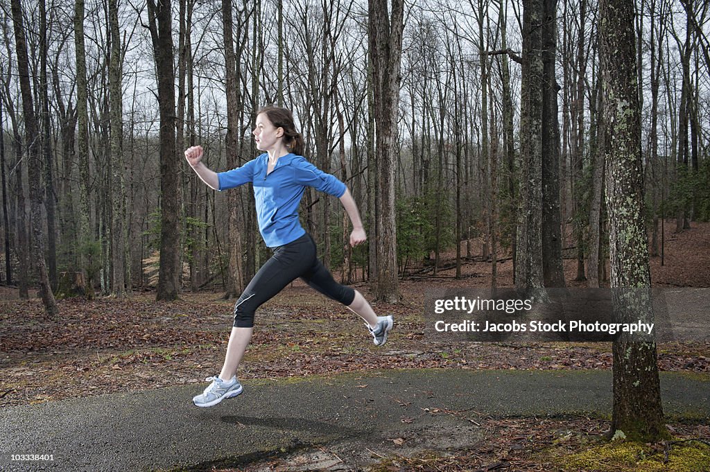 Woman Exercising in Forest