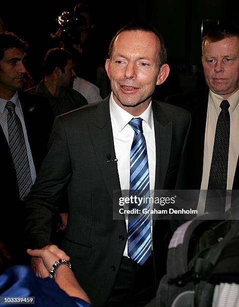 Opposition leader Tony Abbott is greeted by a member of the public after answering questions from swinging voters on August 11, 2010 in Sydney,...