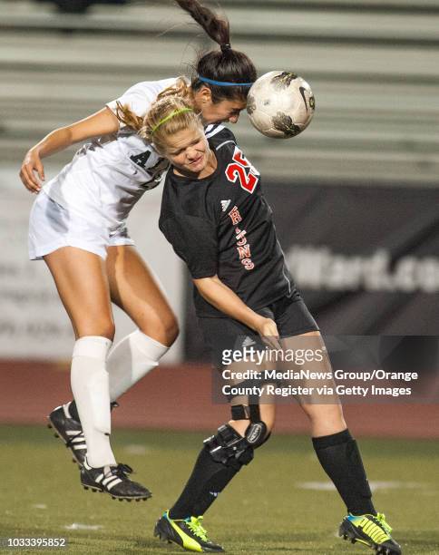 Anissa Raja, left, of Aliso Niguel goes over the shoulder of Audrey Kate Ward of San Clemente in a South Coast League girls soccer game at Aliso...