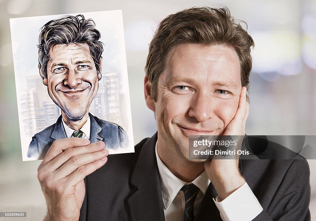 Businessman holding caricature of himself