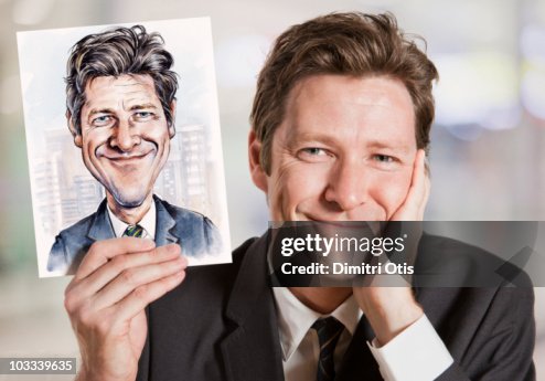 Businessman holding caricature of himself