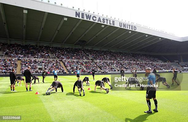 Manager Chris Hughton watches players warm up during a Newcastle United open training session at St James' Park on August 11, 2010 in Newcastle Upon...