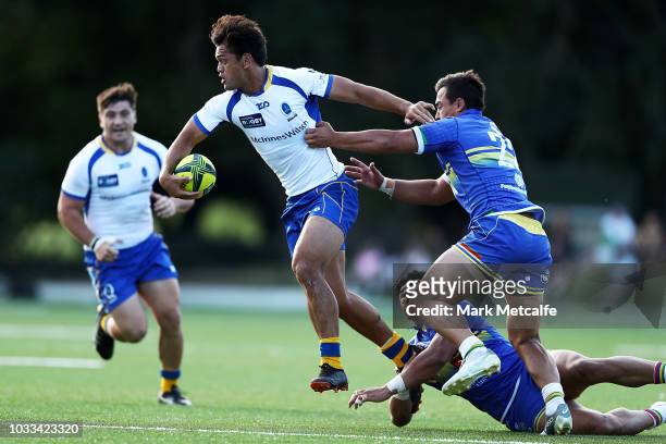 Karmichael Hunt of Brisbane City is tackled during the round three NRC match between Sydney Rays and Brisbane City at Woollahra Oval on September 15,...