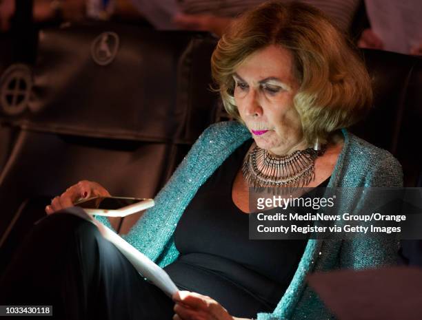 Author Darlene Quinn examines her Oscar ballot with the light from her cell phone during Robert Kline's annual Night at the Oscars event at the...