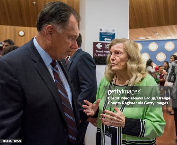 Orange County District Attorney Tony Rackauckas, left, speaks with Collene Campbell, whose son Scott was murdered in 1982, prior to the start of the...