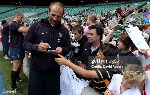 Former England captain Steve Bortwick signs autographs for supporters during the England training session held at Twickenham Stadium on August 11,...