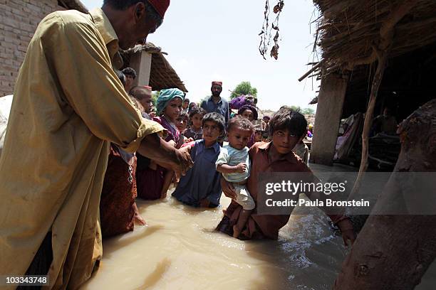 Pakistani flood victims get evacuated by the Pakistan Navy on a boat rescue mission as flood waters continue to rise August 11, 2010 in Sangi Patan,...