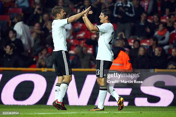 Mario Gomez of Germany celebrates with his team mate Thomas Hitzlsperger after scoring the opening goal during the International Friendly match...