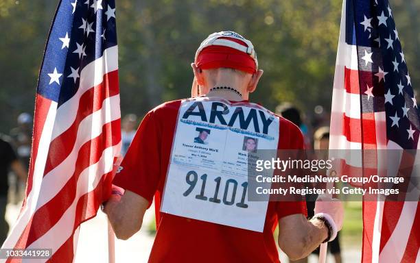 Korean War Veteran and marathon runner Bob Kohler of Irvine wears the names of Army soldiers Trevor Anthony Win'E and Mark J. Daily killed during the...