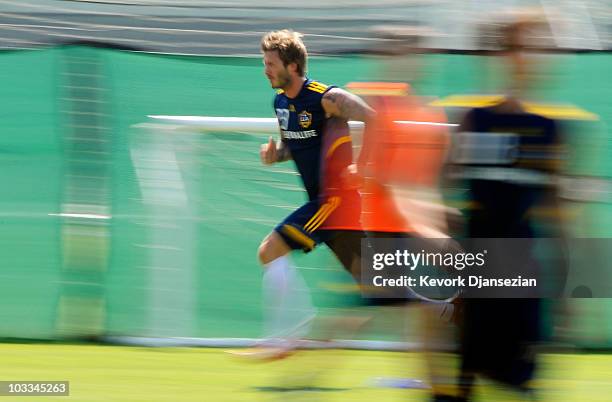 David Beckham of the Los Angeles Galaxy warms up during training session at The Home Depot Center on August 11, 2010 in Carson, California. Beckham...