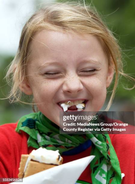 Irvine Girl Scout Abigail Cronn has trouble being neat while eating s'more's during the treat's National day of recognition. She was at day camp near...
