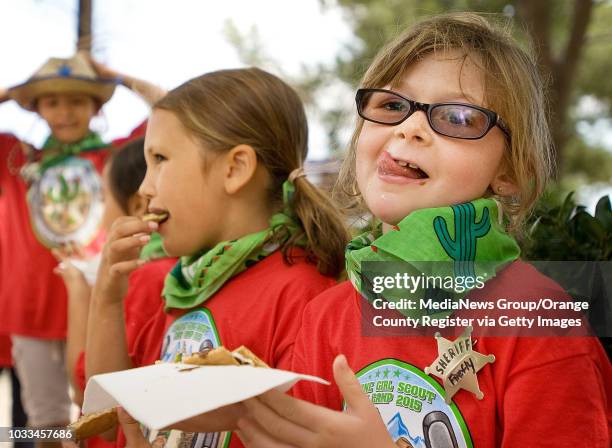 Emily Karpe celebrates National S'mores Day with a lip-licking, gooey, warm creation during Girl Scouts camp in Silverado Canyon on Monday. With her...