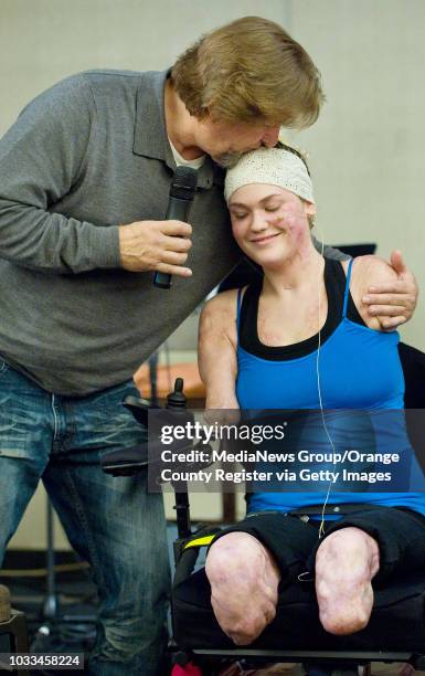 Kaitlyn Dobrow gets a hug from The River Church of OC pastor Carl Tuttle on Sunday after publically sharing her story about surviving meningococcal...