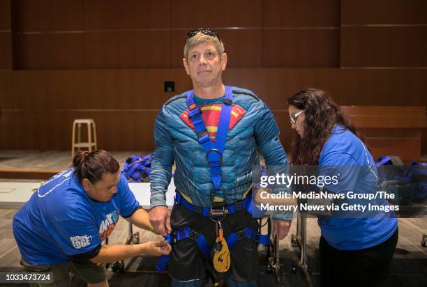 Sunnyvale Mayor Glenn Hendricks gets into his rappelling gear with the help of Downtown Streets Team staff Christine Gonzalez, left, and project...