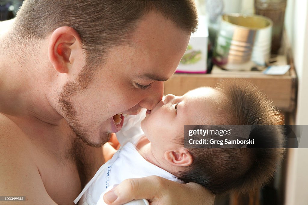 Newborn with fohawk latches onto father's nose