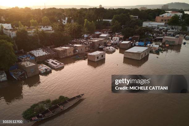 An aerial view shows a part of the Bozo village, on the outskirts of the Malian capital Bamako, flooded by Niger's waters following heavy rain, on...