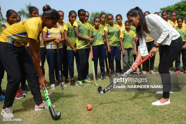 Indian national hockey captain Rani Rampal plays field hockey during her visit to the Khalsa Hockey Academy in Amritsar on September 15, 2018.