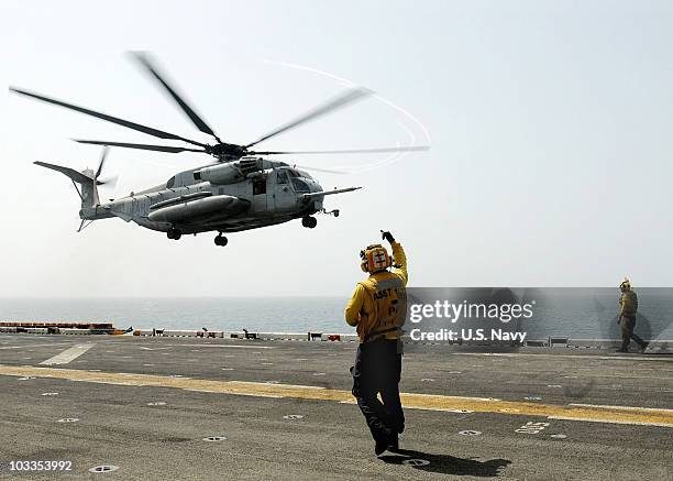 In this handout from the U.S. Navy, a U.S. Marine Corps helicopter assigned to Marine Medium Helicopter Squadron 165 lifts off from the amphibious...