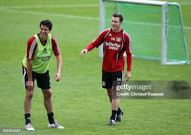 Michael Ballack and Hanno Balitsch laugh during the training session of Bayer Leverkusen at the training ground on August 12, 2010 in Leverkusen,...