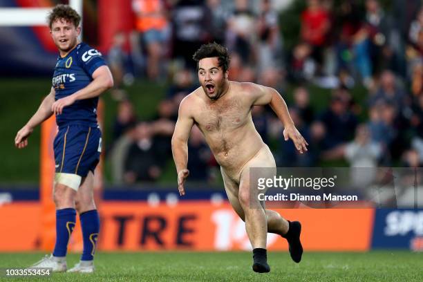 Mitchell Scott of Otago looks on as a pitch invader runs by during the round five Mitre 10 Cup match between Southland and Otago at Rugby Park...