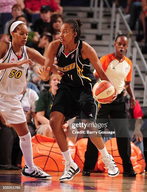 Amber Holt of the Tulsa Shock handles the ball against Tangela Smith of the Phoenix Mercury during a WNBA game on July 17, 2010 at U.S. Airways...