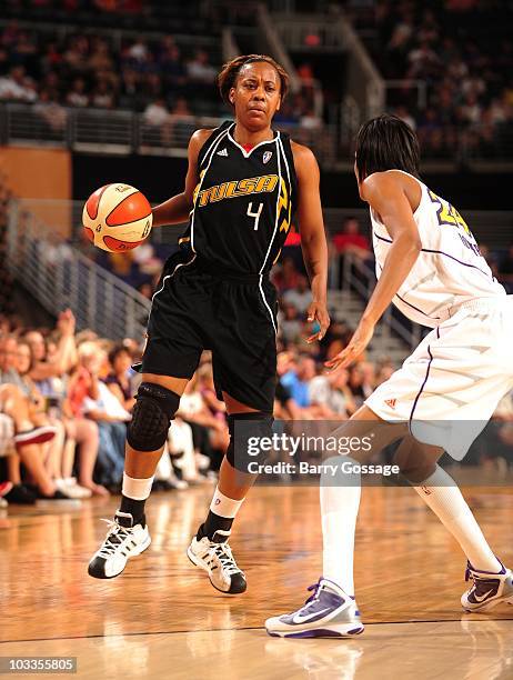 Amber Holt of the Tulsa Shock handles the ball during a WNBA game against the Phoenix Mercury on July 17, 2010 at U.S. Airways Center in Phoenix,...