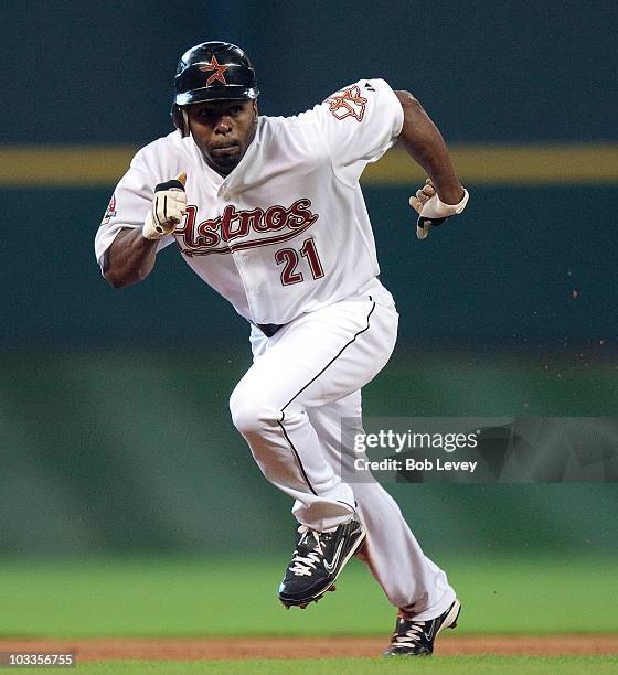 Michael Bourn of then Houston Astros steals third base against the Atlanta Braves at Minute Maid Park on August 11, 2010 in Houston, Texas.