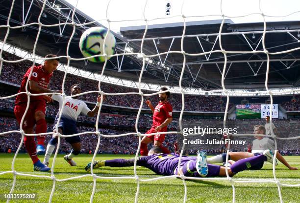 Roberto Firmino of Liverpool scores his team's second goal past Michel Vorm of Tottenham Hotspur during the Premier League match between Tottenham...