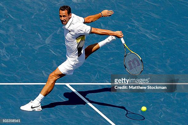Michael Llodra of France returns a shot to Roger Federer of Switzerland during the Rogers Cup at the Rexall Centre on August 12, 2010 in Toronto,...