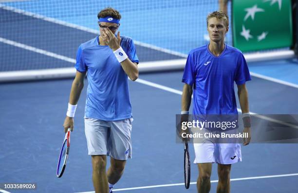 Denis Istomin and Sanjar Fayziev of Uzbekistan show thier dejection against Jamie Murray and Dominic Inglot of Great Britain during day two of the...