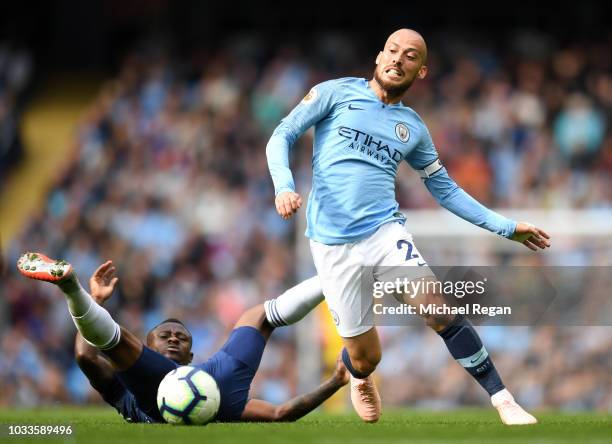 David Silva of Manchester City is challenged by Jean Michael Seri of Fulham during the Premier League match between Manchester City and Fulham FC at...