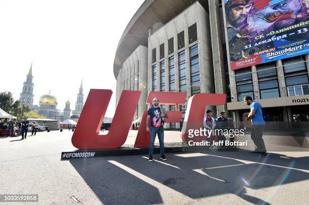 Fans take a photo in front of the UFC letters during the UFC Fan Experience at the UFC Fight Night event at Olimpiysky Arena on September 15, 2018 in...