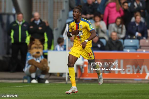 Wilfried Zaha of Crystal Palace celebrates after scoring his team's first goal during the Premier League match between Huddersfield Town and Crystal...