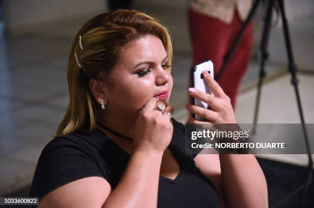 Contestant puts makeup on backstage during the "Miss Gordita" beauty contest in Asuncion, on September 14, 2018. - Eleven plus-size women competed...