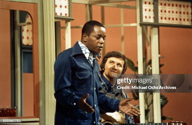 Comedian Flip Wilson sings with a man in a scene from the Flip Wilson Show in circa 1972.