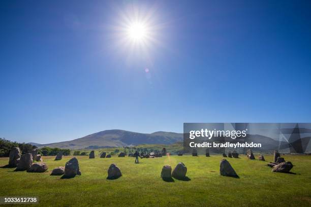 mother spins daughter inside castlerigg stone circle in the english lake district - stone circle stock pictures, royalty-free photos & images