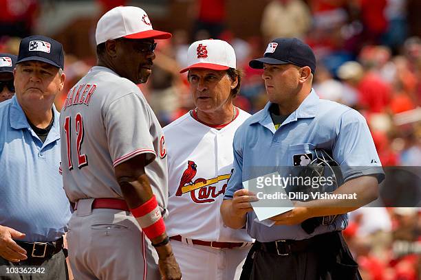 Tony LaRussa of the St. Louis Cardinals, Dusty Baker the Cincinnati Reds and umpires Jerry Crawford and Scott Barry meet before the game at Busch...