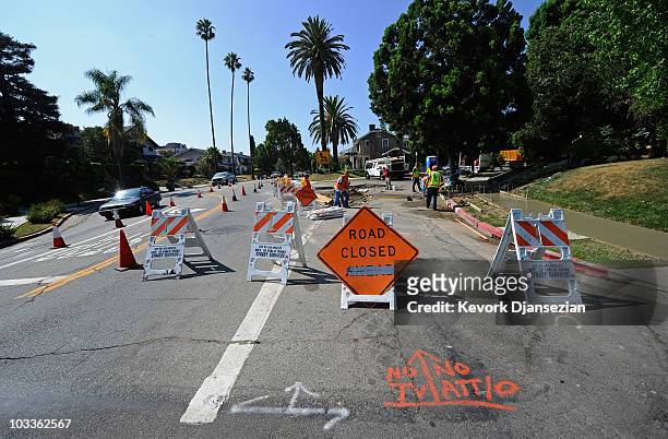 City of Los Angeles Public Works Department Street Services workers repair a sidewalk on August 12, 2010 in Los Angeles, California. The state of...