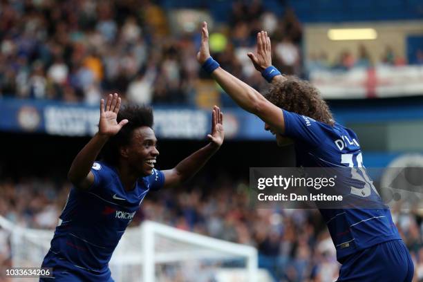 Willian of Chelsea celebrates after scoring his team's fourth goal with David Luiz during the Premier League match between Chelsea FC and Cardiff...