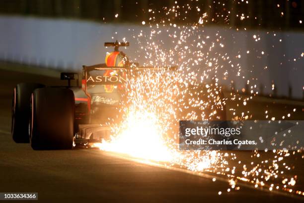Sparks fly behind Daniel Ricciardo of Australia driving the Aston Martin Red Bull Racing RB14 TAG Heuer on track during qualifying for the Formula...