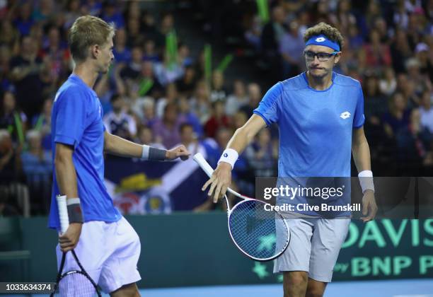 Denis Istomin and Sanjar Fayziev of Uzbekistan show thier dejection against Jamie Murray and Dominic Inglot of Great Britain during day two of the...