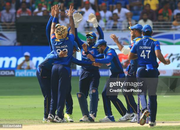 Sri Lankan cricketers celebrate during the first cricket match of Asia Cup 2018 between Sri Lanka and Bangladesh in Dubai, United Arab Emirates,...