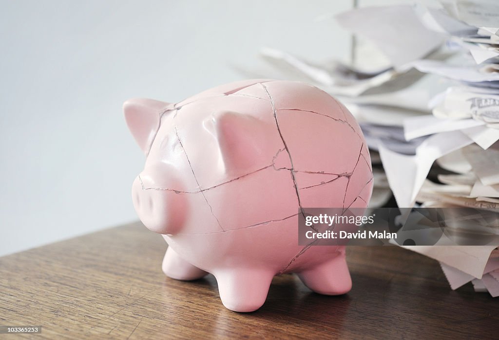 Repaired piggy bank, on desk with Receipts